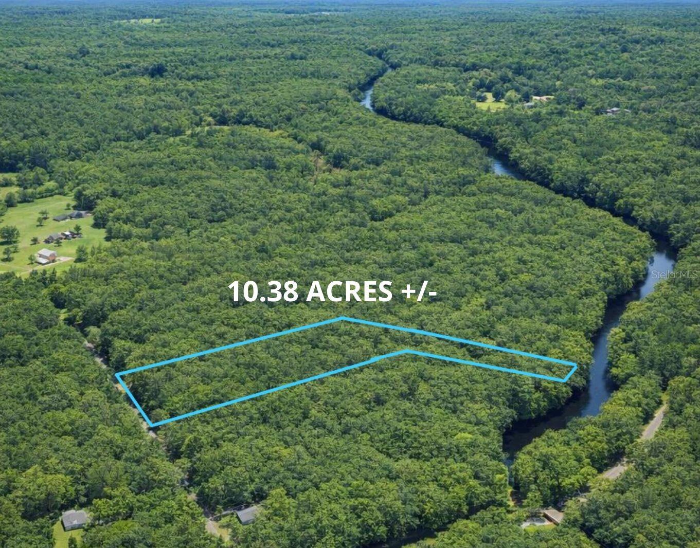 Aerial view of a wooded area showing a 10.38-acre plot outlined in blue, with a river winding through the landscape.